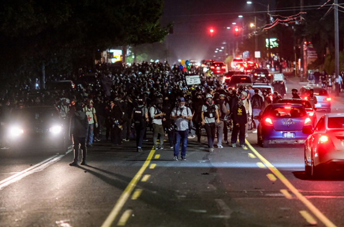 A crowd 1,000 strong march toward the East Precinct.