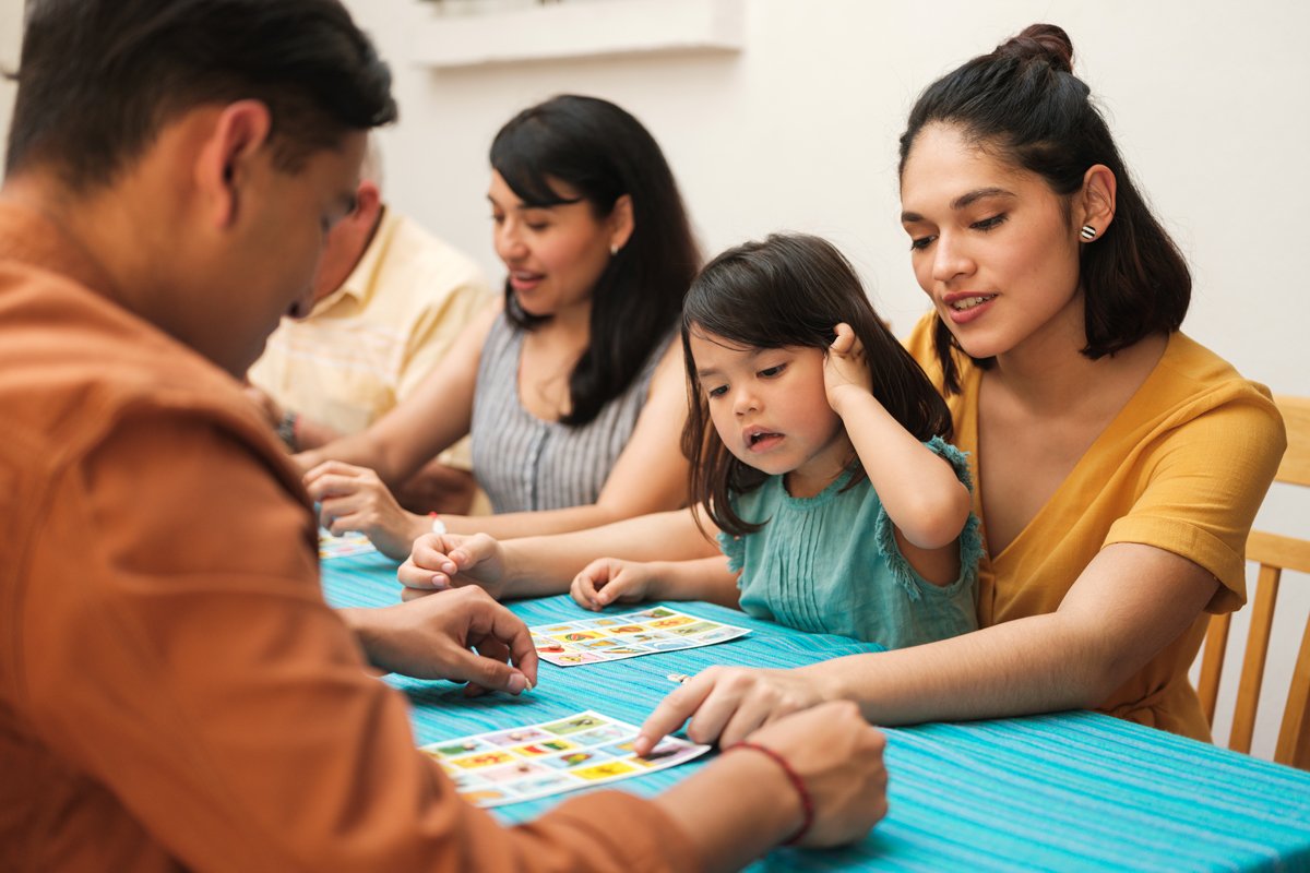 A family play a game together. 