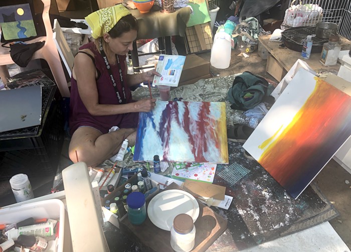Alma Barrett works on a painting at her Laurelhurst camp Wednesday.