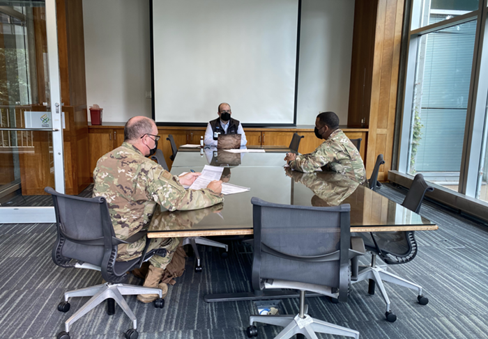 Members of the Oregon National Guard in a meeting with an OHSU official.