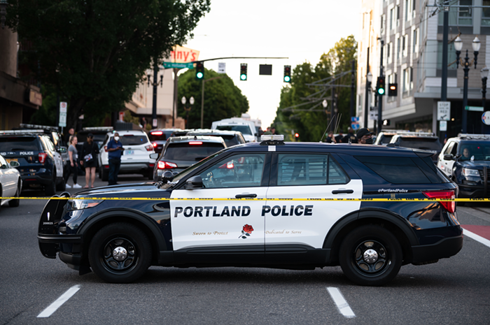 A Portland police car behind crime scene tape