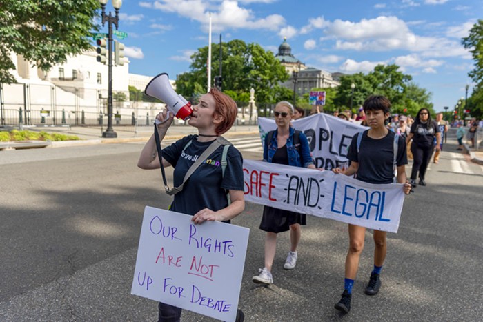 Protesters march near the Supreme Court to demand an end to gun violence and call for abortion rights protection.